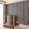 Vertical wood grain peel-and-stick wall tiles in gray and beige tones installed on a modern interior wall.
