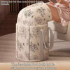 A white foldable calf-height foot soaking tub is shown on a surface, with a hand resting near it.