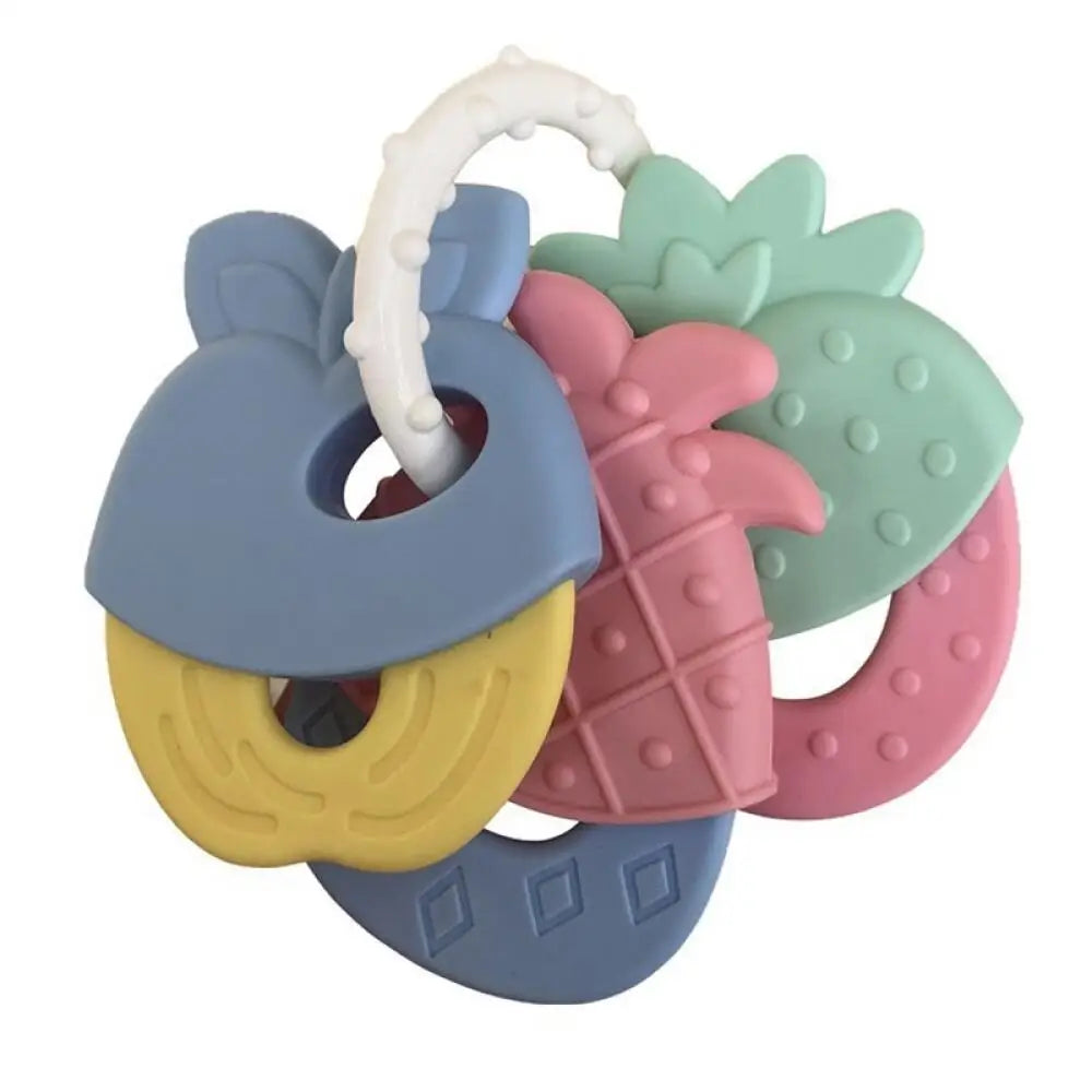A set of silicone fruit teethers and a rattle for babies in pastel colors like blue, yellow, pink, and green.