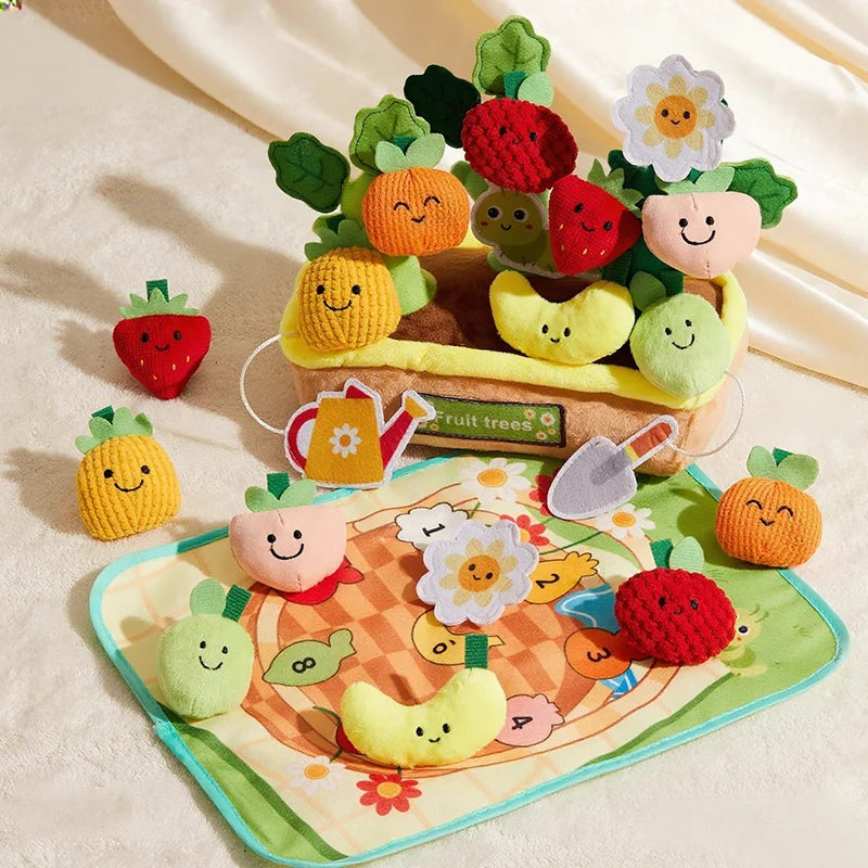 A collection of felt fruit and vegetable toys, including carrots, strawberries, and pumpkins, arranged in a display.