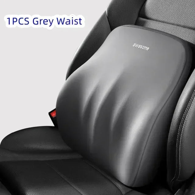 A grey memory foam waist pillow is shown placed in a car seat for lumbar support.