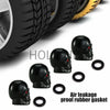 A set of four black skull design rubber gaskets used as air leakage proof valve stem caps for tires