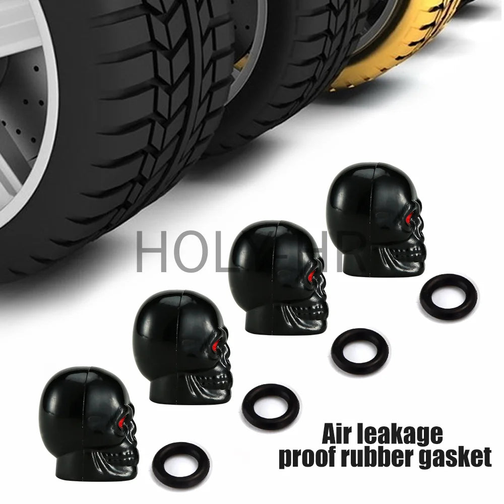 A set of four black skull design rubber gaskets used as air leakage proof valve stem caps for tires