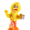 A yellow Elmo hand puppet plush toy with large eyes and orange body wearing striped pants.