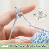 A hand holds a light blue crochet tension ring for crocheting next to a finished yarn piece.