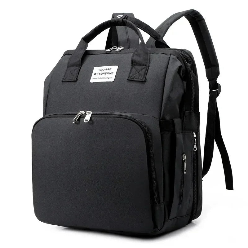 Black large capacity diaper bag backpack with a shoulder strap and zippered compartments