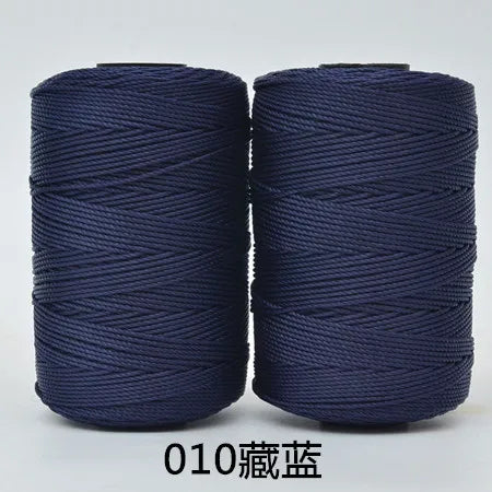 Two spools of dark blue 3-ply polyester knitting yarn for crochet and hand crafts