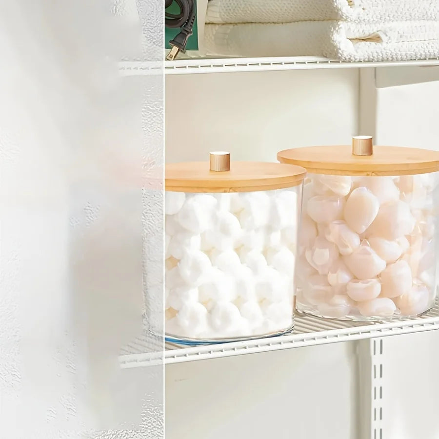 Clear acrylic storage container filled with white detergent pods on a white shelf.