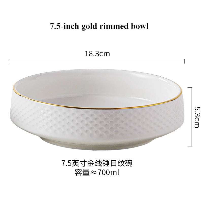 A white ceramic rimmed bowl with a gold rim, measuring 7.5 inches and having a capacity of about 700ml.