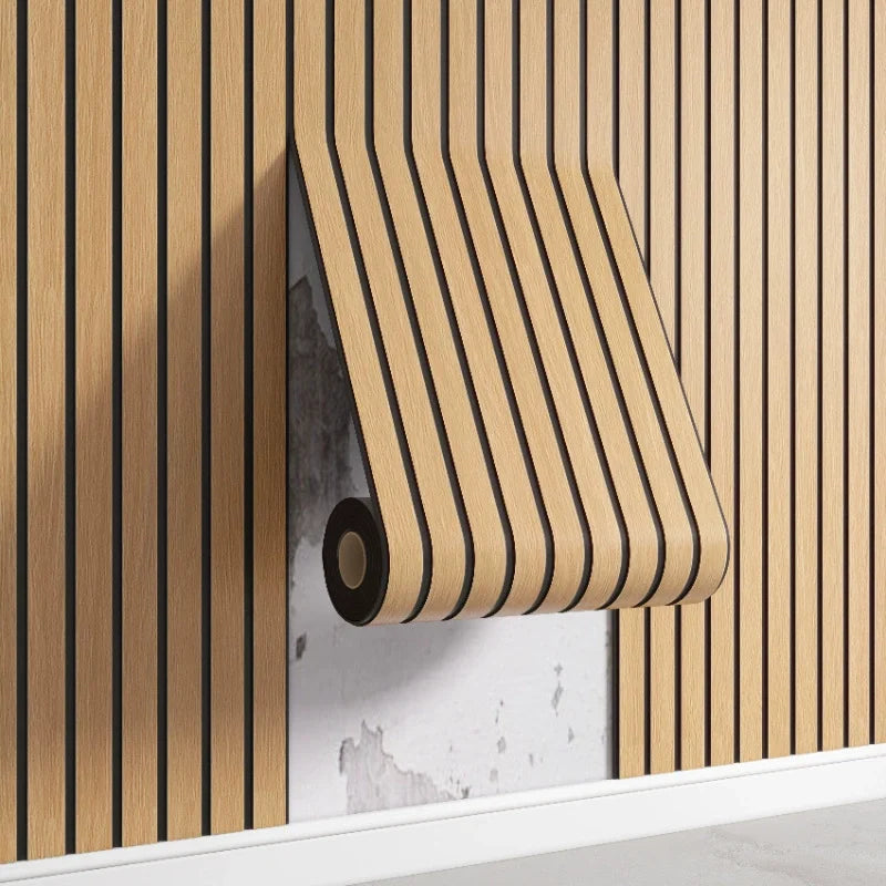 A close-up of a beige wood grid peel-and-stick wall panel installed vertically on a light gray wall.