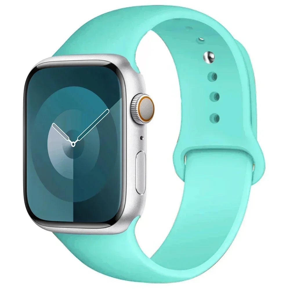 A silver Apple Watch encased in a light mint green silicone sport band.