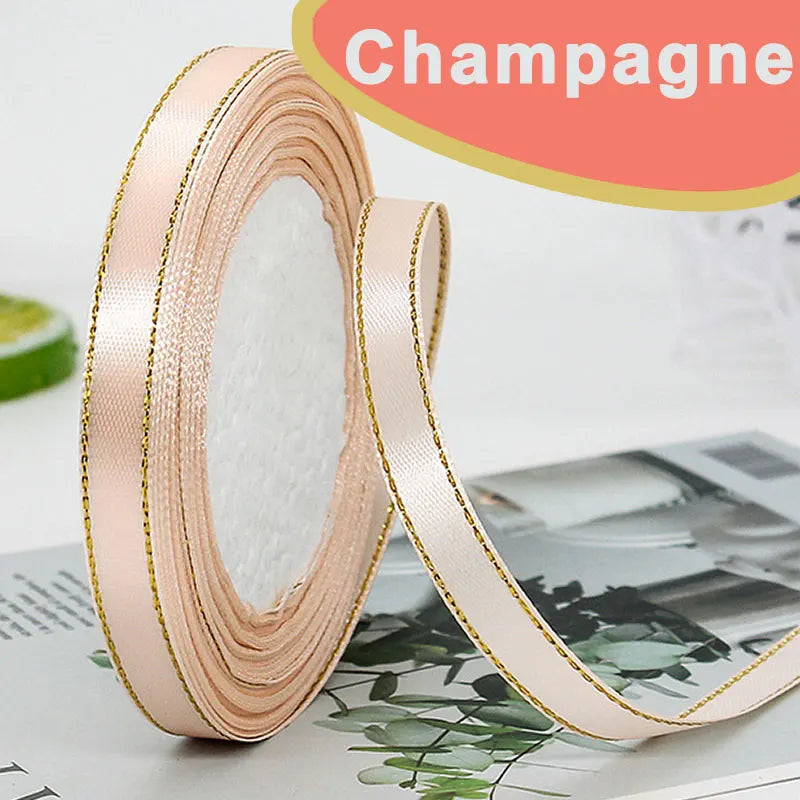 Roll of pink satin ribbon with gold edge for crafts and gift wrapping