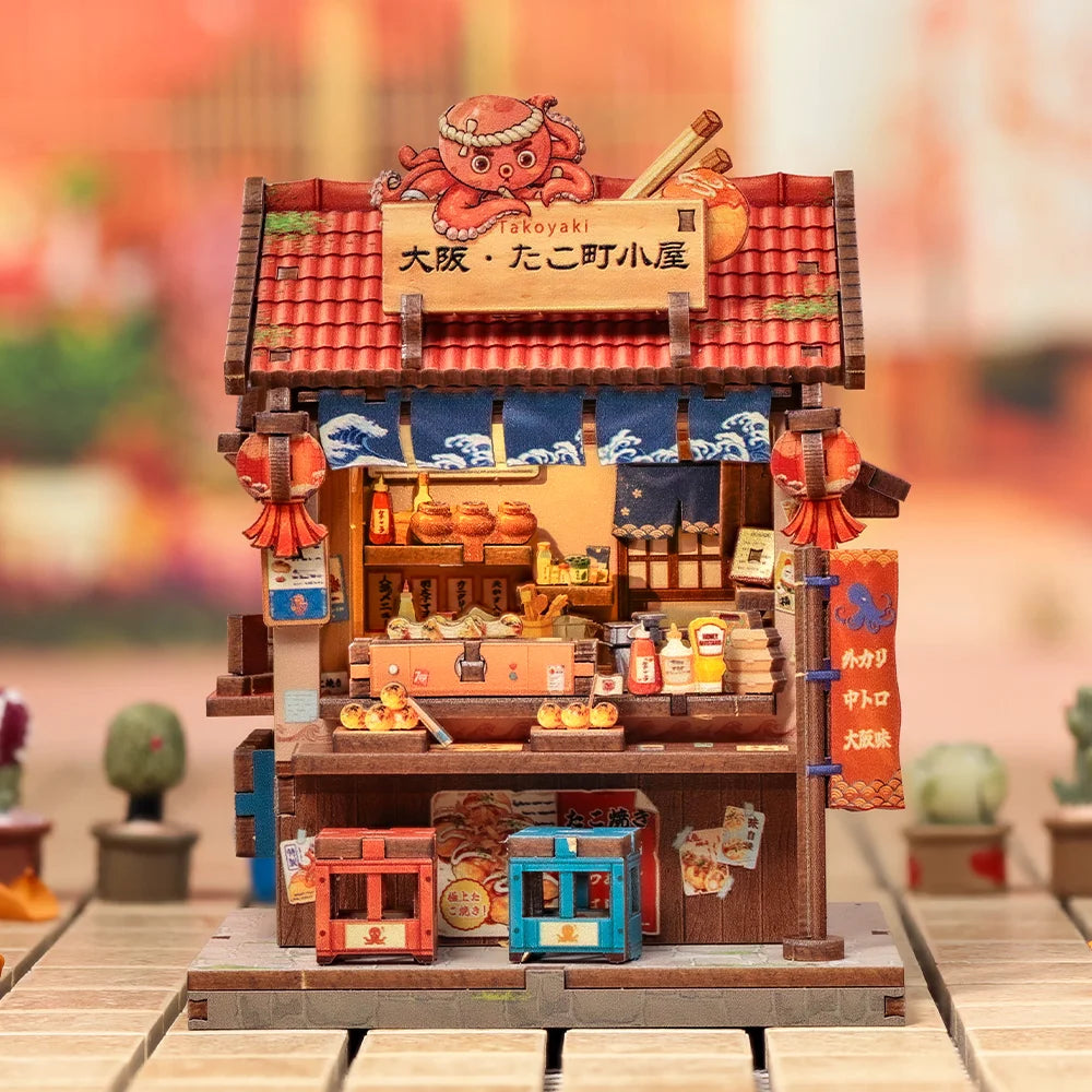 A detailed miniature kit of a Japanese house featuring a traditional roof and storefront, complete with wooden elements and l