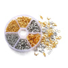 A collection of gold and silver jewelry findings including lobster clasps, jump rings, and crimps organized in a clear plasti