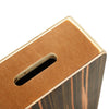 A close-up view of a compact travel cajon drum with wood grain finish and a slotted opening.