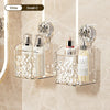 Clear glass wall-mounted storage basket with a white water ripple design holding perfume bottles and a small glass jar