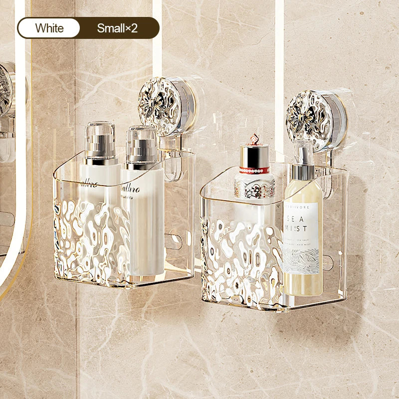 Clear glass wall-mounted storage basket with a white water ripple design holding perfume bottles and a small glass jar