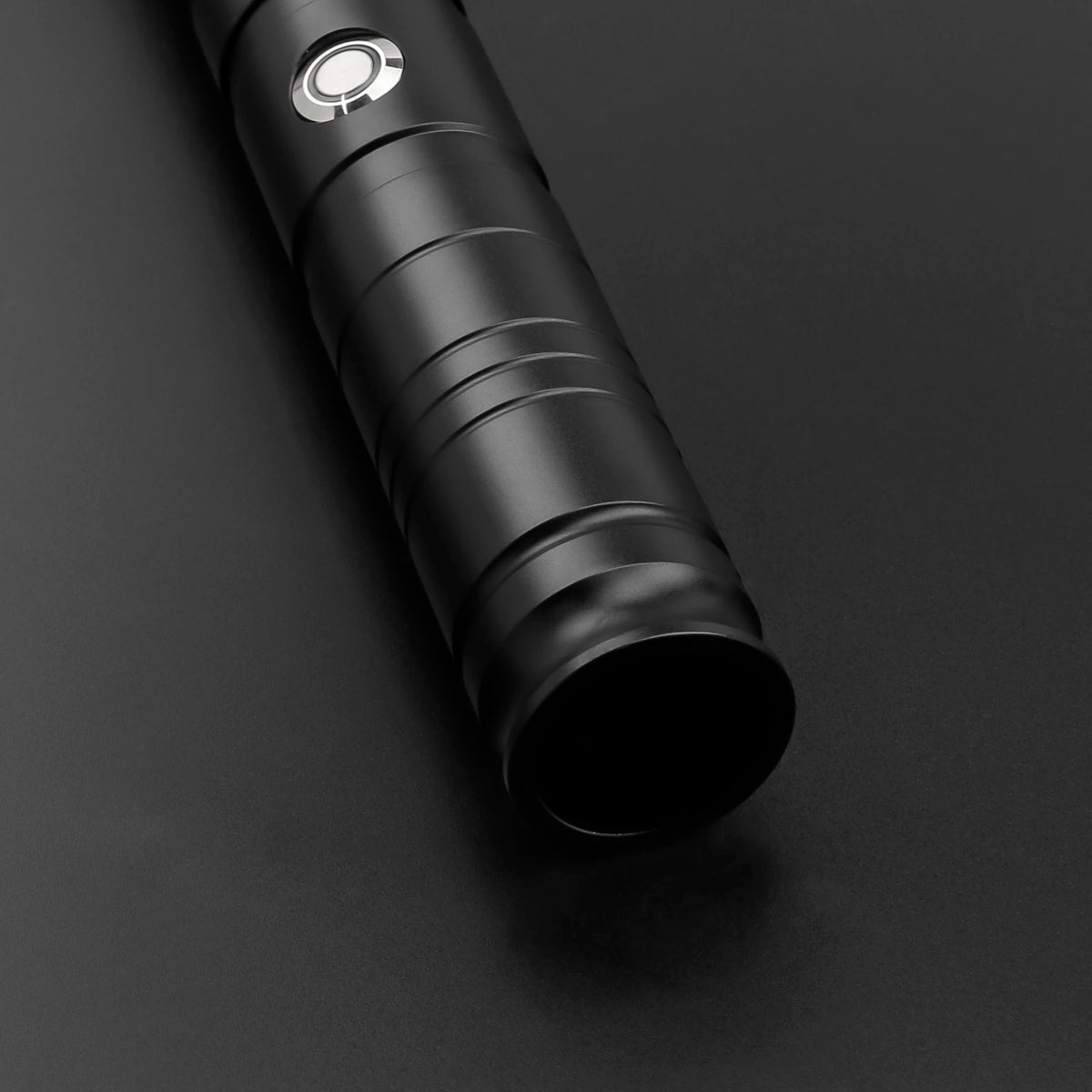 A black lightsaber hilt with an RGB blade is shown in a close-up view against a dark background.