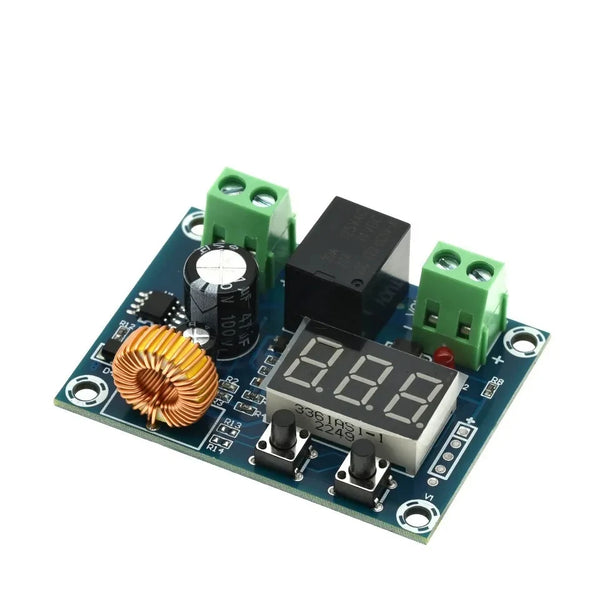 A green electronic module with a black connector and a gold-colored battery terminal is shown on a circuit board.