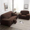 A dark brown silky soft stretchable sofa cover for pet owners displayed on a light rug.