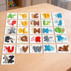 A set of wooden letter matching cards for spelling words, featuring animals and objects from A to Z.