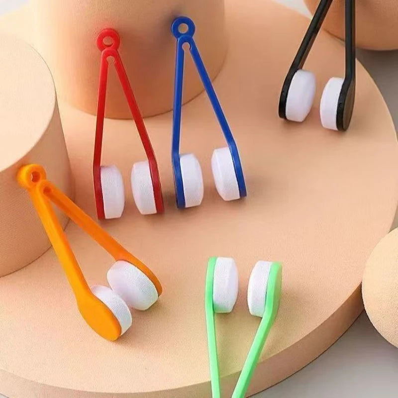 A collection of colorful portable microfiber glasses cleaning cloths with brushes displayed on a light pink surface.