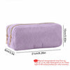 A lavender, ribbed pencil case with a double zipper is shown lying flat.