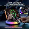 A smartphone is charging on an auto-aligning clamp arm mount with RGB ambient light and one-key locking mechanism in a car in