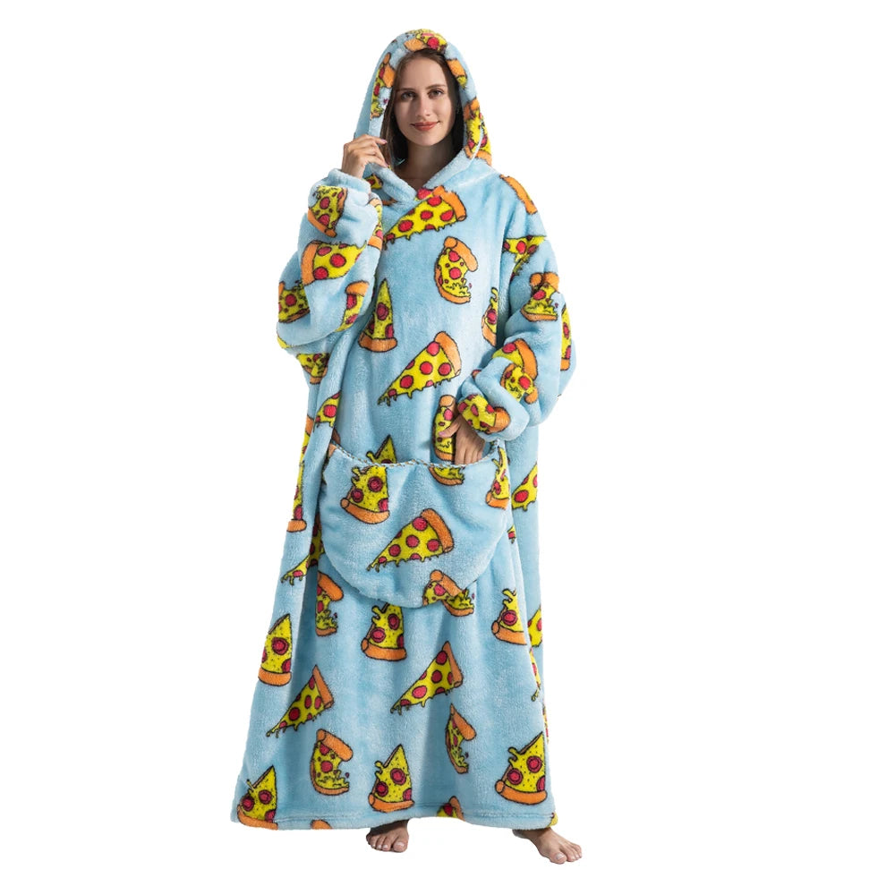 A woman wearing a blue fuzzy hoodie blanket decorated with yellow and orange pizza graphics.