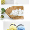 A collection of soft 4-ply milk cotton yarn in various shades of yellow, green, and blue is displayed.