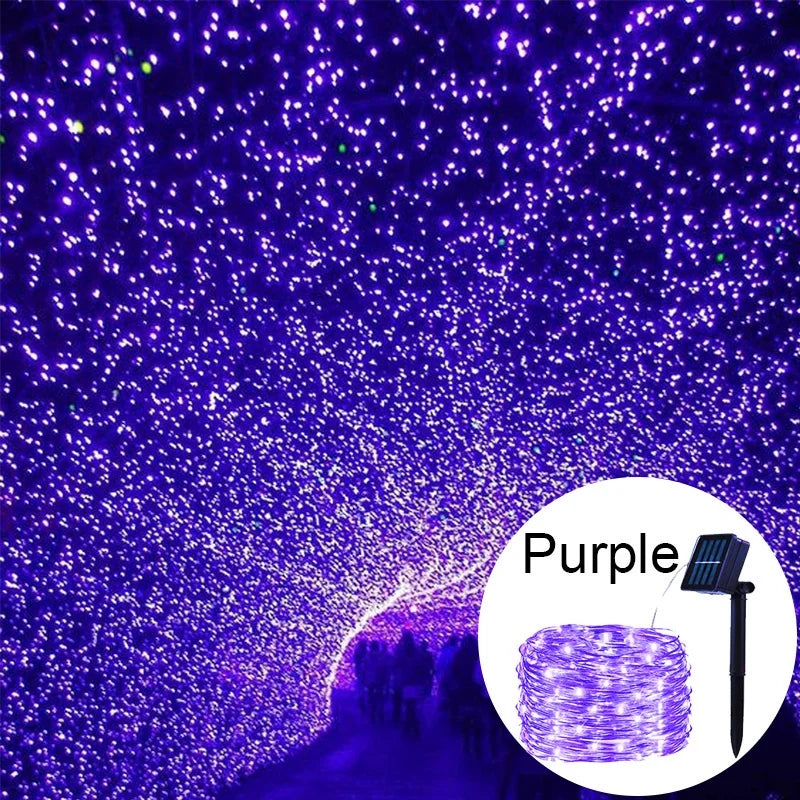 Purple fairy string lights illuminating a tunnel or pathway at night