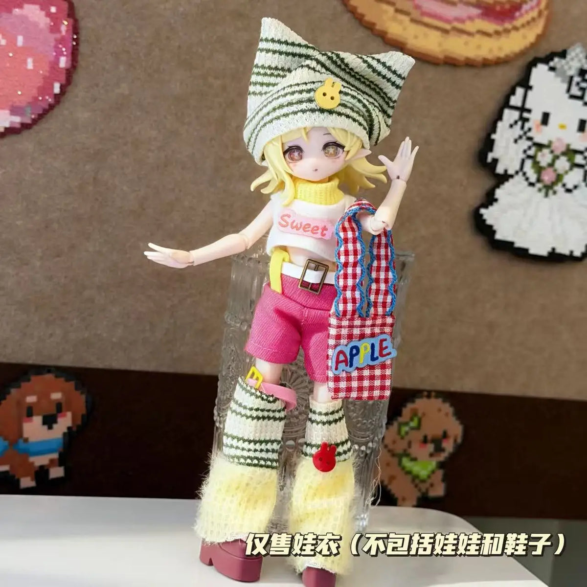 A female doll dressed in a sweet maid outfit featuring a striped hat, pink shorts, and yellow leg warmers.
