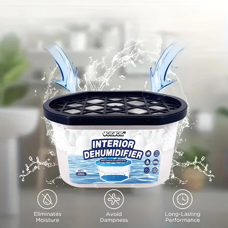 A white interior dehumidifier box with a black lid is shown surrounded by water spray, emphasizing its ability to eliminate m