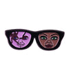 Enamel pin featuring a stylized, menacing doll face with purple and brown tones.
