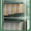 A set of five anti-slip stainless steel hangers with clips for pants and skirts displayed in a white rack.