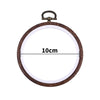 A round wooden embroidery hoop with a metal clamp, used for cross-stitch and needlework.