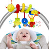 A plush spiral crib and stroller activity toy with hanging rattles is shown above a baby.