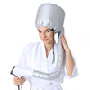 A woman is holding a silver reusable hair drying and conditioning cap.