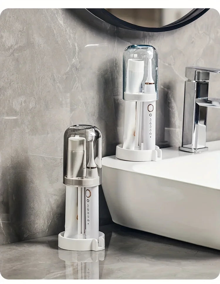 Modern bathroom toothbrush holder with a clear dust cover and drainage system on a white countertop.