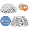 A collection of silver metal pin badges and buttons in various sizes, including a circular example and a pile of round pins.