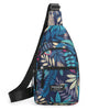 A dark blue and teal leaf print sling crossbody bag with a black strap and zippered pockets.