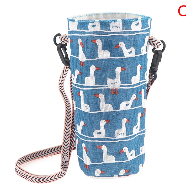 A blue and white patterned canvas water bottle crossbody bag with black straps.