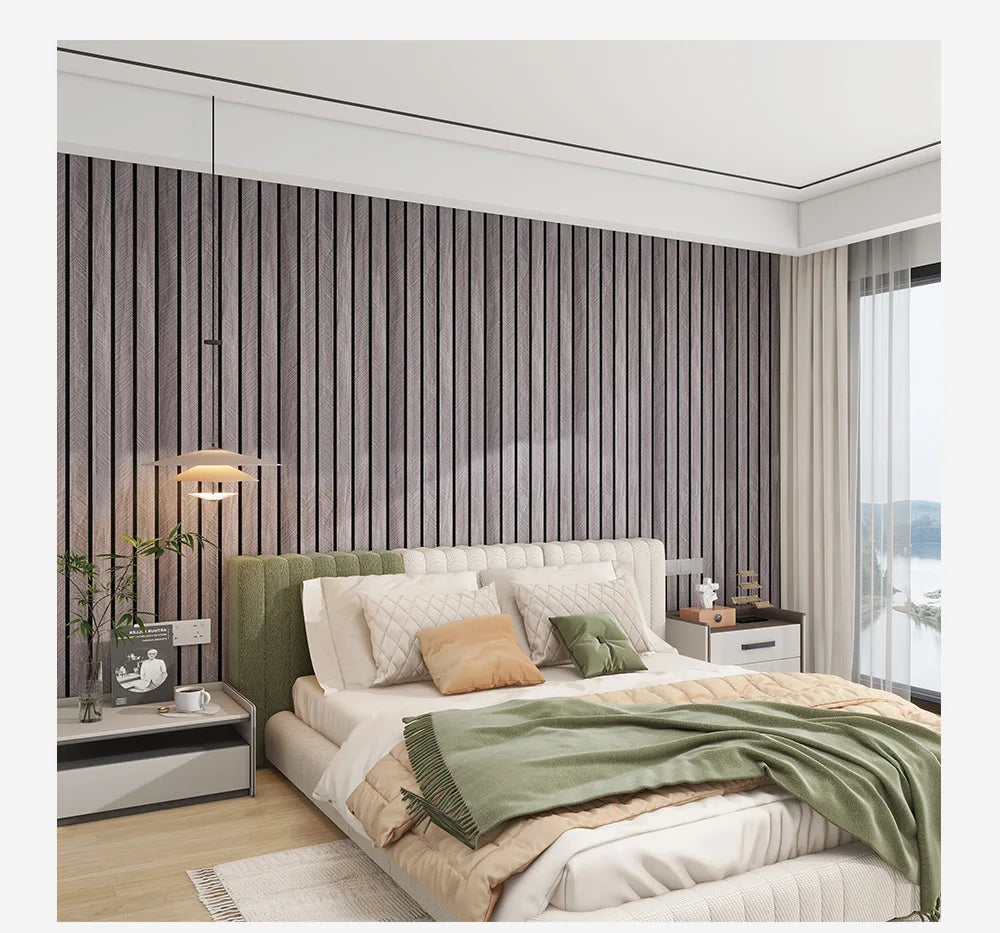 A bedroom featuring a bed with light green bedding and a textured wood grain wallpaper accent wall.