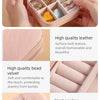 A pink PU leather jewelry storage box with multiple compartments and a neat car line stitching.