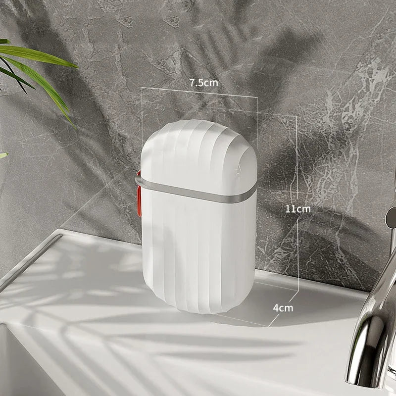 A white portable travel soap box with a drainage lid is shown on a light surface against a gray marbled background.