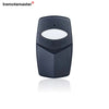 A black garage door remote control with a white lens and a dip switch visible.