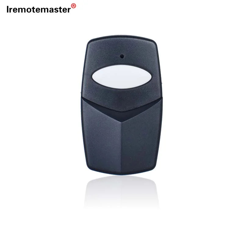 A black garage door remote control with a white lens and a dip switch visible.