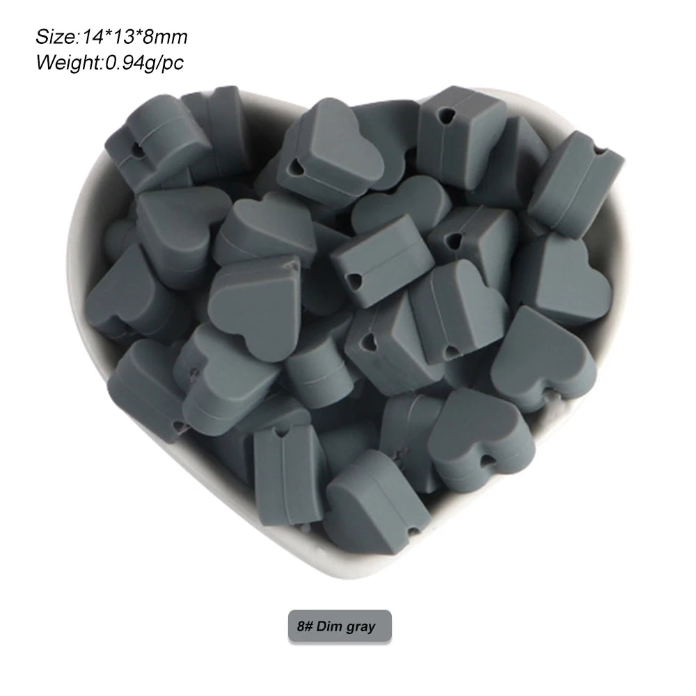 A pile of 8mm dim gray silicone crown star heart beads for DIY jewelry making.