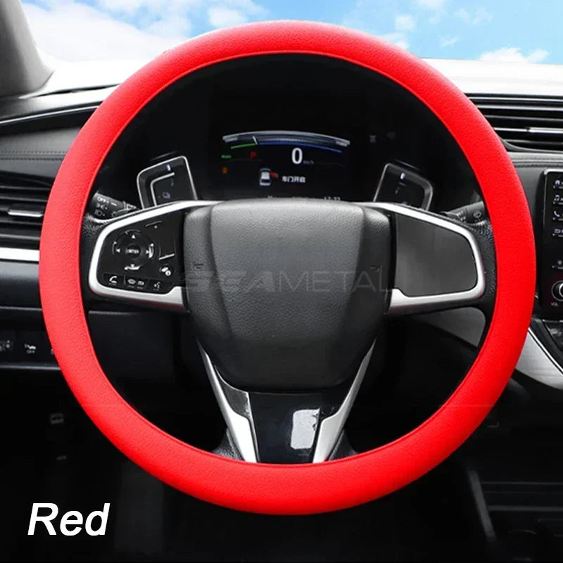 A red silicone steering wheel cover is shown inside a car's interior, featuring a modern steering wheel and dashboard visible