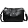Black leather compact square crossbody bag with gold hardware and double-deck storage.